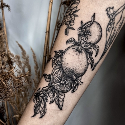 Orange branch tattoo in a dark style
