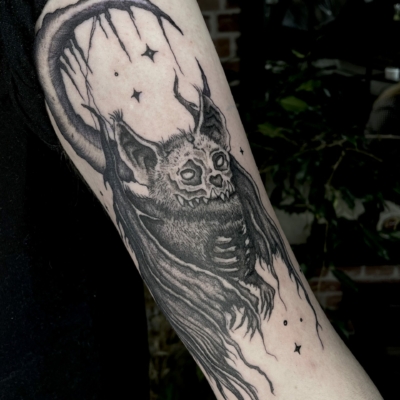 Bat tattoo with a moon and stars background in a dark halloween style.