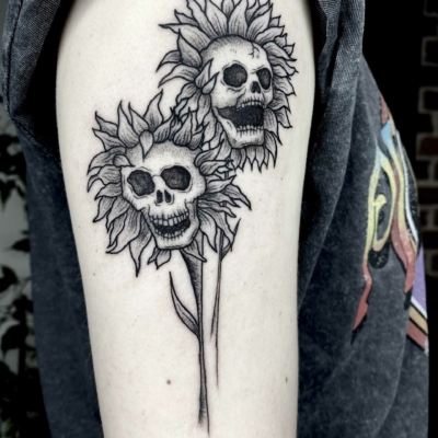Skeleton flowers tattoo inspired by Halloween decorations.
