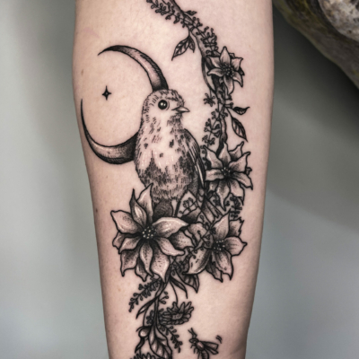 Bird in flowers delicate tattoo made for a best friend in a tattoo studio.