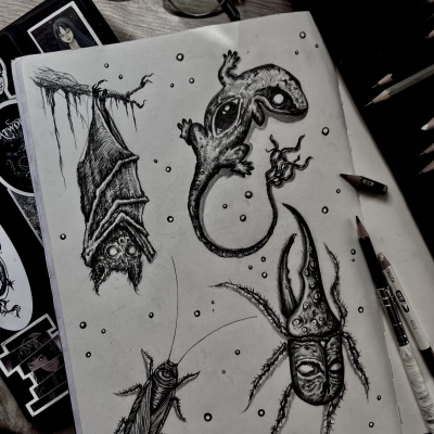 Various sketches of creepy animals like a bat, a cockroach, a gecko and a bug.