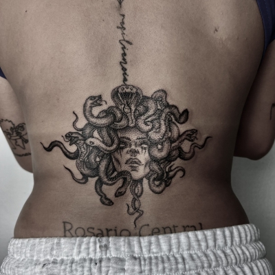 Medusa tattoo on a woman´s lower back